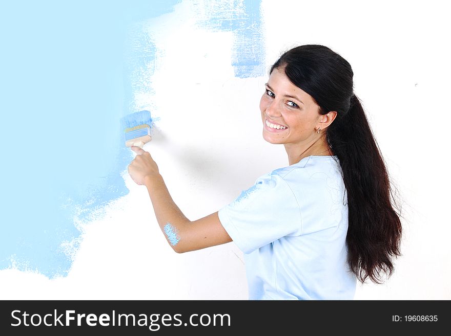 Woman paints the wall brush. Woman paints the wall brush