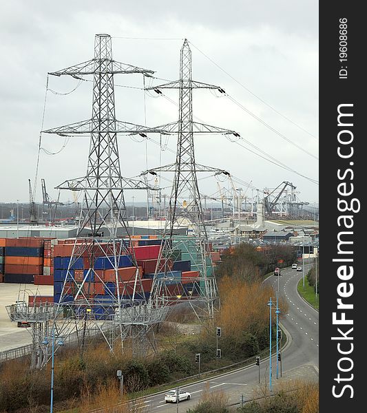 A corner of a busy citys industrial area showing docks, electricity pylons and a road junction. A dull corner of a city on a dull day. A corner of a busy citys industrial area showing docks, electricity pylons and a road junction. A dull corner of a city on a dull day