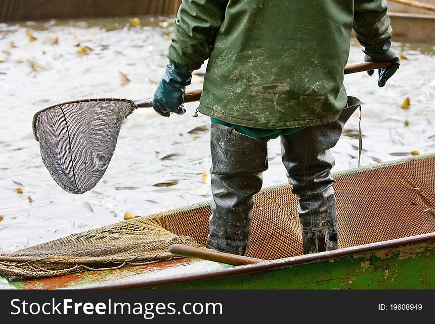 Detail of fisherman harvesting pond