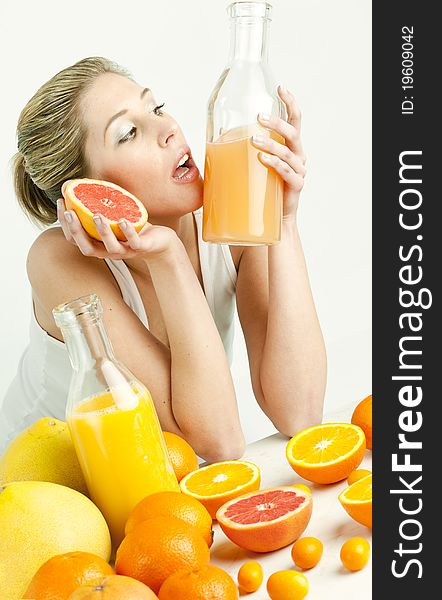 Portrait of young woman with citrus fruit and orange juice