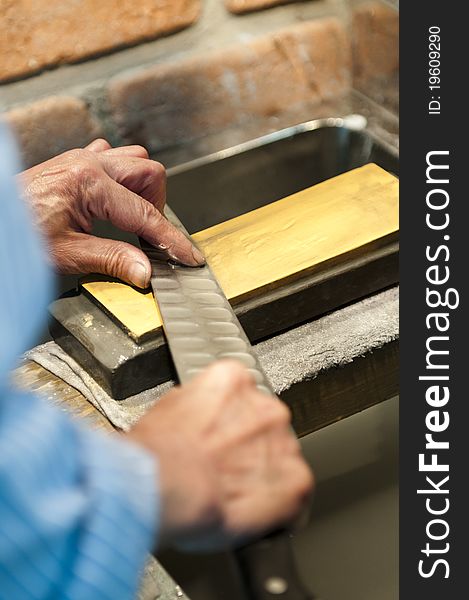 A Japanese gentlemen is sharpening knives in Japan. A Japanese gentlemen is sharpening knives in Japan.