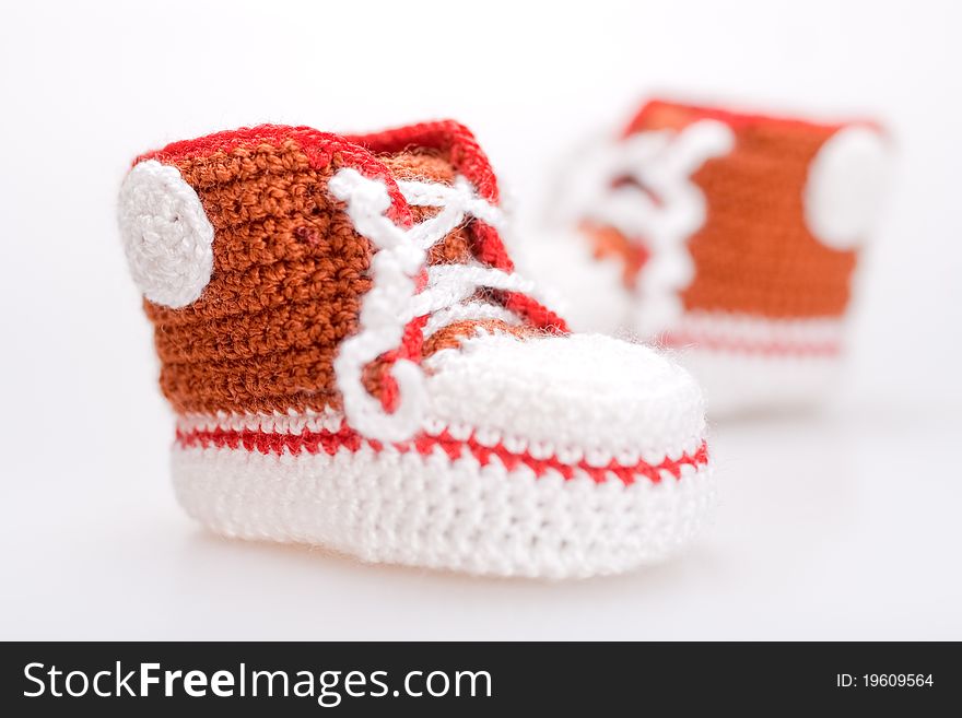 Crocheted booties for a boy on a gray background