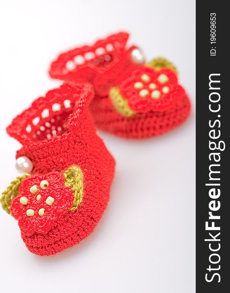 Crocheted booties for a girl on a gray background