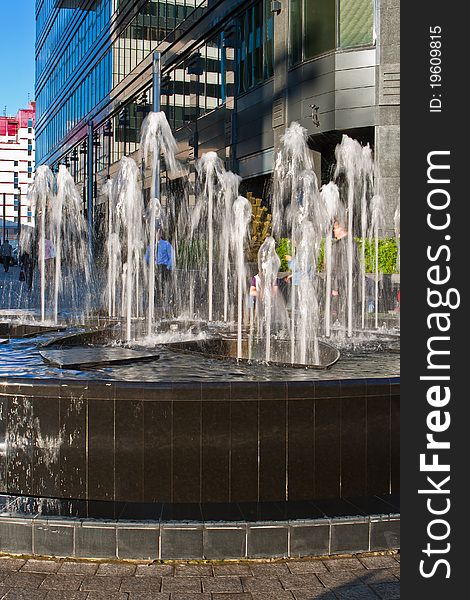 Fountain on the small area between modern buildings in downtown. Fountain on the small area between modern buildings in downtown