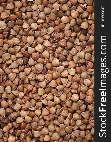 Natural buckwheat grains texture background, close up