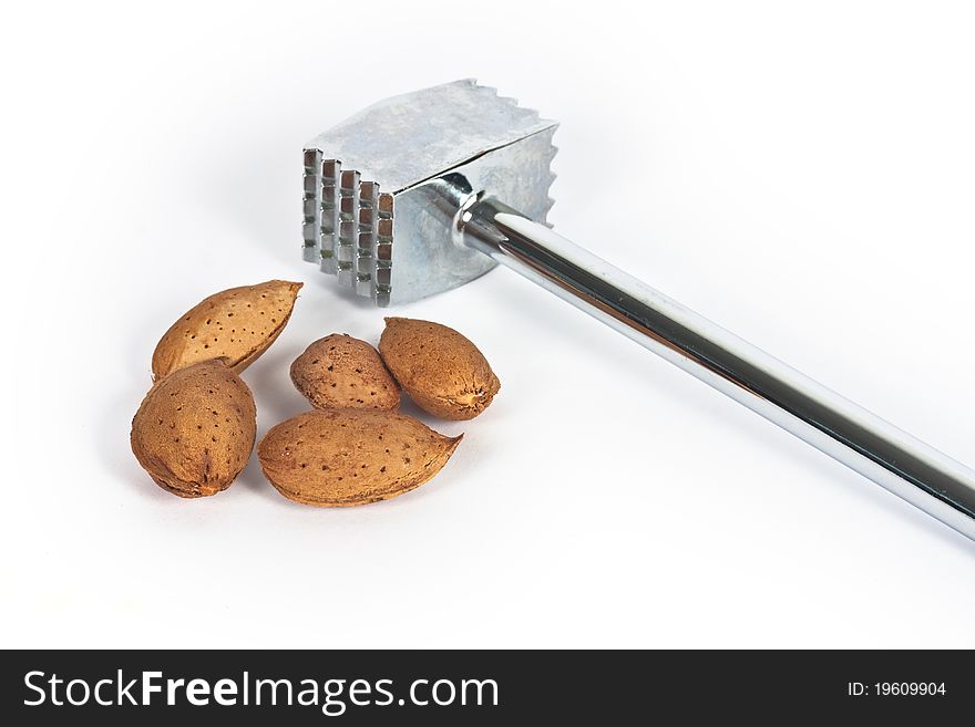 Almond nut with hammer, isolated. Almond nut with hammer, isolated