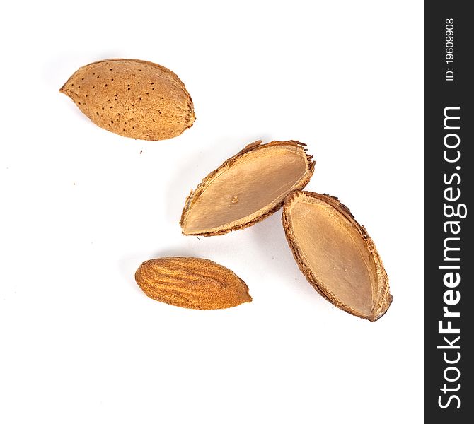 One opened and ona close almond nut on white background