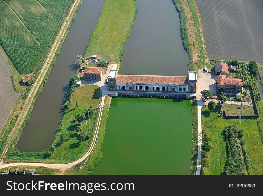 Barrier dam on the river with green water and scooping campaign