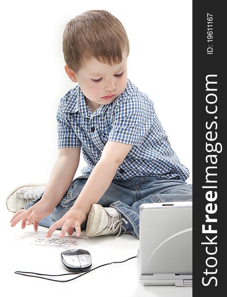 Cute young boy with laptop over white