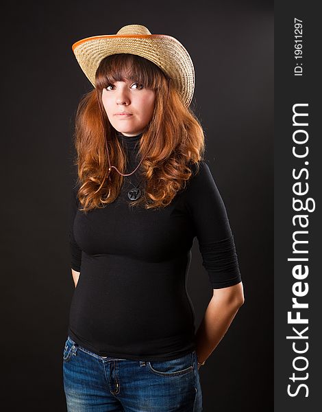 Beautiful girl in a cowboy hat on black background. Beautiful girl in a cowboy hat on black background