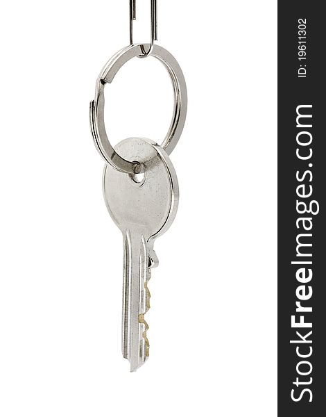 Single key hanging on a key ring over white