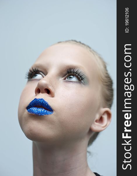 Close-up portrait of young teen girl with beauty blue mouth.