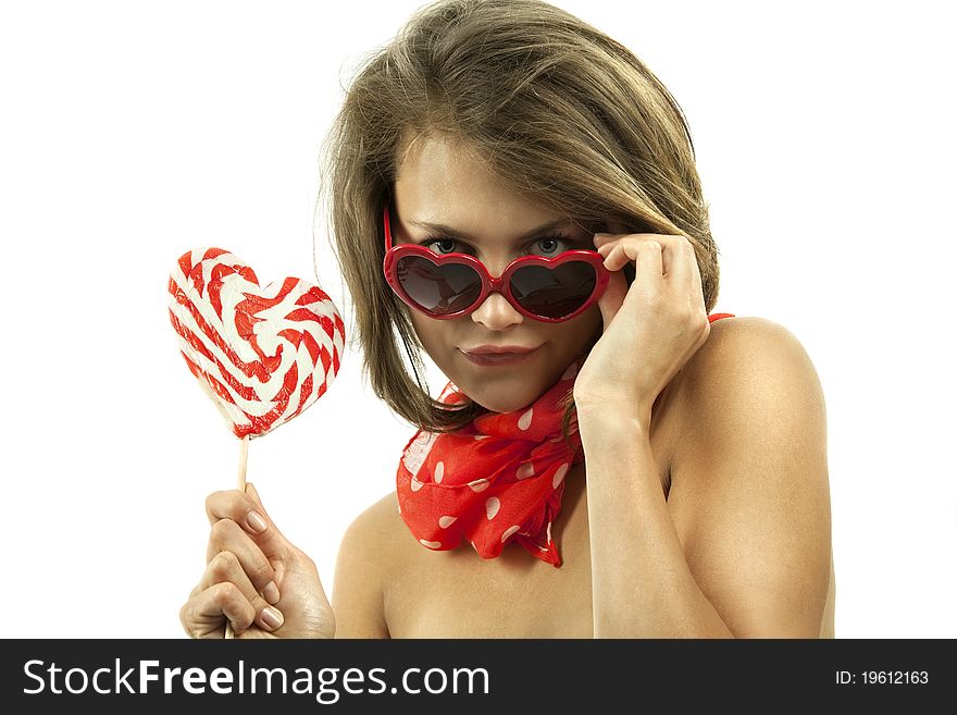 Close-up portrait of young woman with heart shaped lollipop and sunglasses. Close-up portrait of young woman with heart shaped lollipop and sunglasses