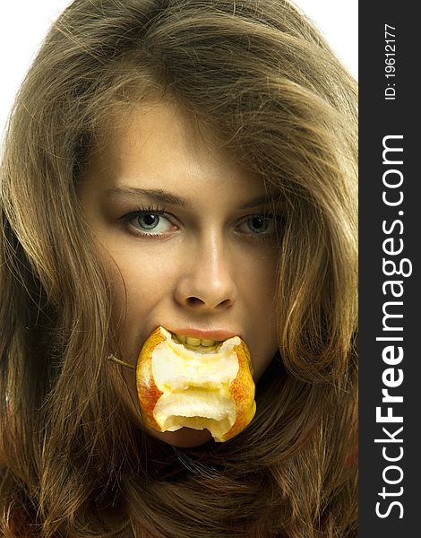 Young beautiful woman with bit of an apple in her mouth