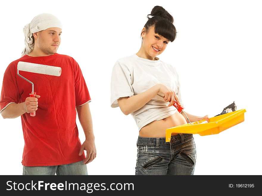 Cheerful young couple of workers preparing to painting a wall