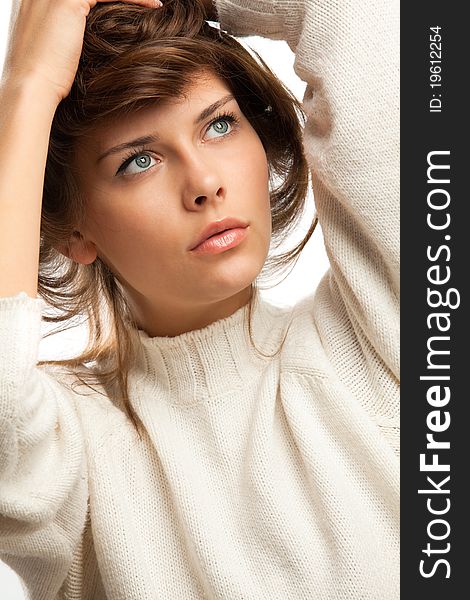 Portait of attractive girl in white wool sweater over white