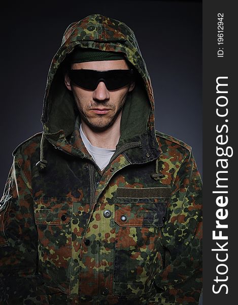 Soldier in camouflage and ammunition
