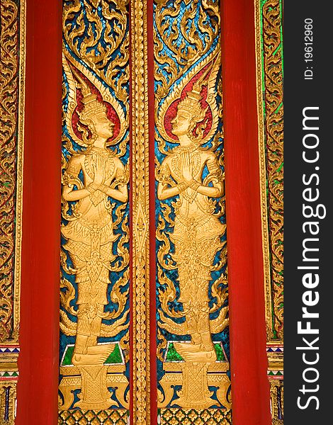 Wood engraving on the doors of Buddha church in  Thailand. Wood engraving on the doors of Buddha church in  Thailand