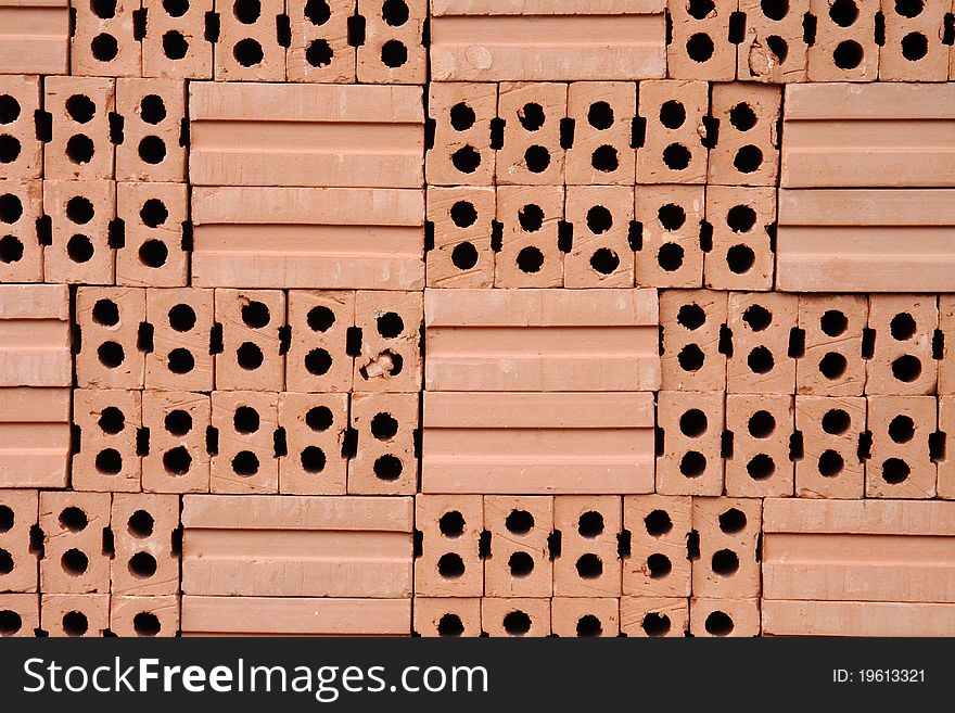 Pile of red bricks for construction.