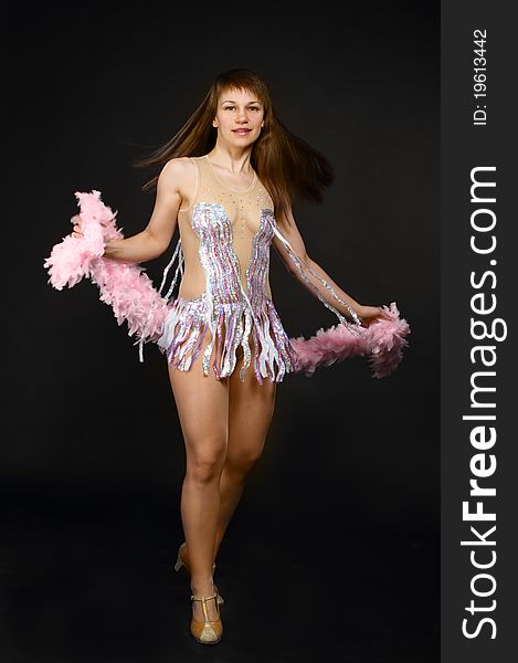 Beautiful dancing woman posing on studio background