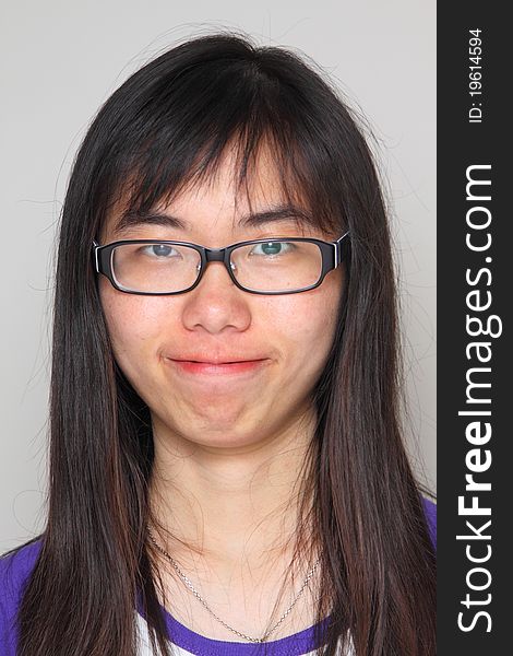 She is wearing glasses and typical asian. She is wearing glasses and typical asian.