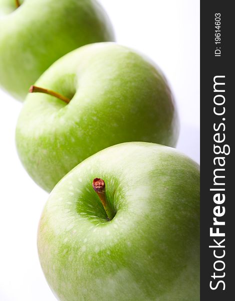 Three ripe green apples. On white background