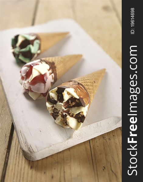 Ice cream cones with various fillings photographer om a wooden board