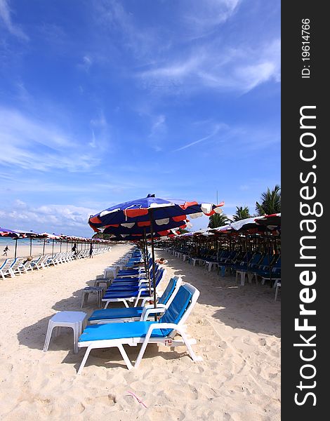 Group of canvas bed and beach umbrellas placing on the Cha-am beach of Thailand