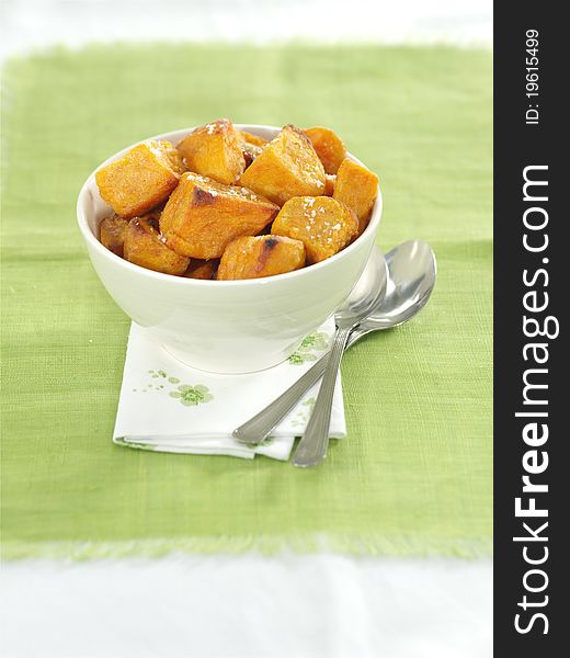 Potato wedges with garnish and isolated on a white background with lime green tablecloth