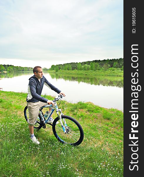Young man on a bicycle in forest
