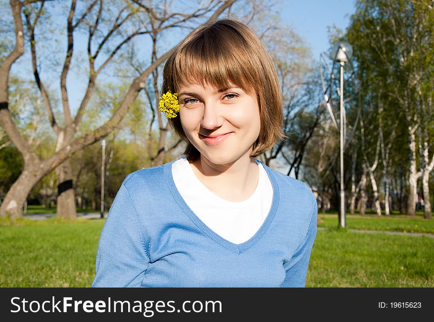 Smiling Girl Sitting In The Park