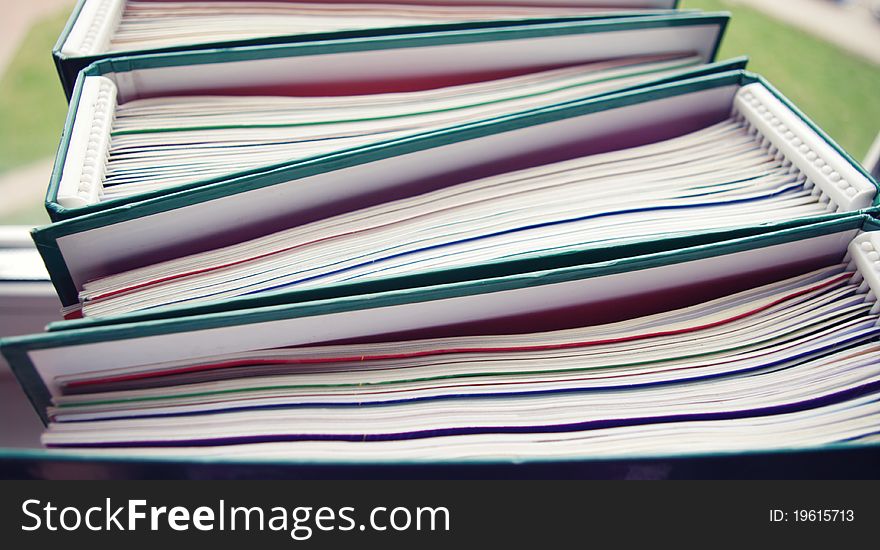 A stack of magazines in folders