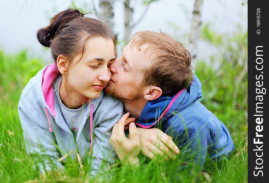 Portrait of a happy couple lying together on grass