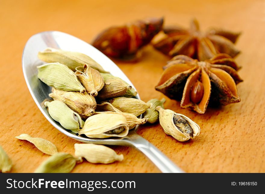 Anise, cardamom and spoon on the table. Anise, cardamom and spoon on the table