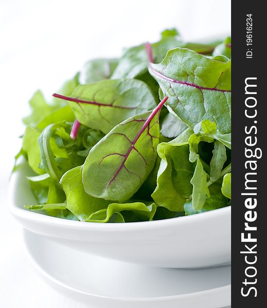 A bowl of mixed lettuce. Shallow depth of field, selective focus