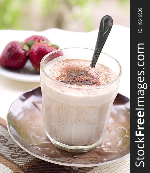 A glass of fresh coffee latte with cocoa