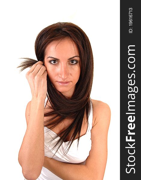 A beautiful young woman in a white blouse standing in the studio 
bringing her long hair around her neck, for white background. A beautiful young woman in a white blouse standing in the studio 
bringing her long hair around her neck, for white background.