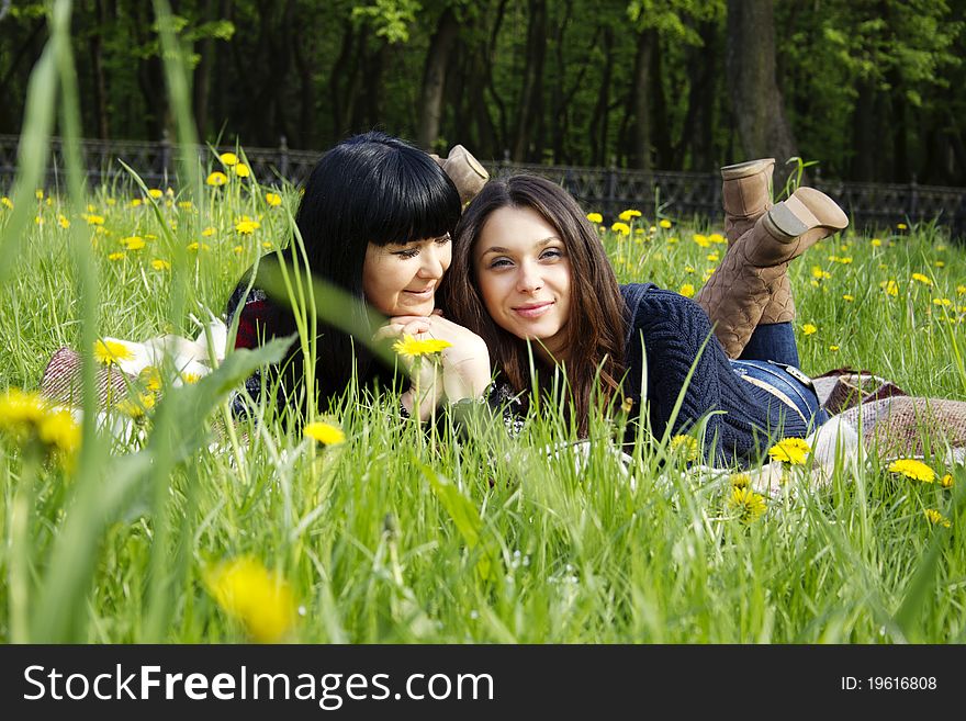 Portrait of a smiling mother and teenage daughter in park. Portrait of a smiling mother and teenage daughter in park