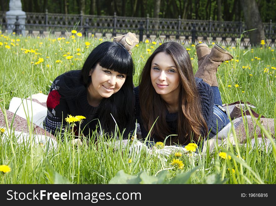 Portrait of a smiling mother and teenage daughter in park. Portrait of a smiling mother and teenage daughter in park