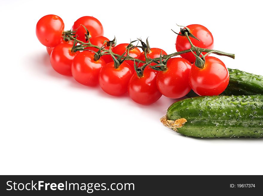 Cherry tomatoes and cucumbers on a white background. Cherry tomatoes and cucumbers on a white background