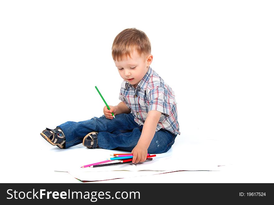 Two, three years old baby boy sitting with color pencil drawing isolated on a white background. Two, three years old baby boy sitting with color pencil drawing isolated on a white background