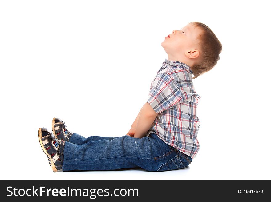 Cute little boy sitting look up to empty copy space isolated on white background. concept. Cute little boy sitting look up to empty copy space isolated on white background. concept.
