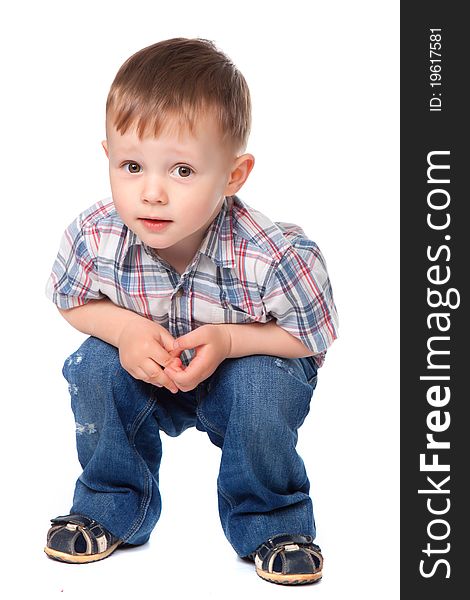 Cute little boy sitting isolated on white background. looking at camera. concept. Cute little boy sitting isolated on white background. looking at camera. concept.