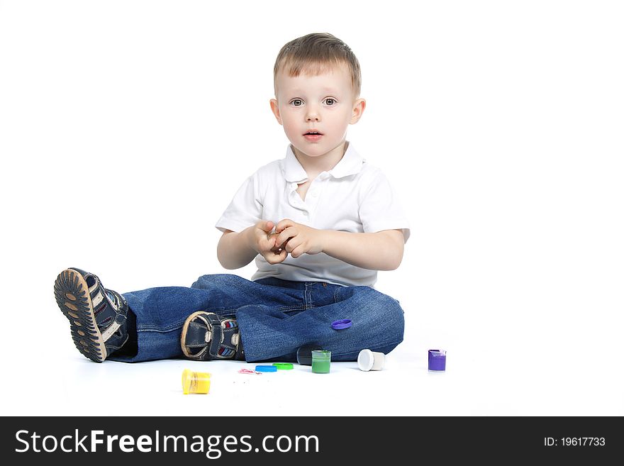 Two, three years old baby boy paints isolated on a white background