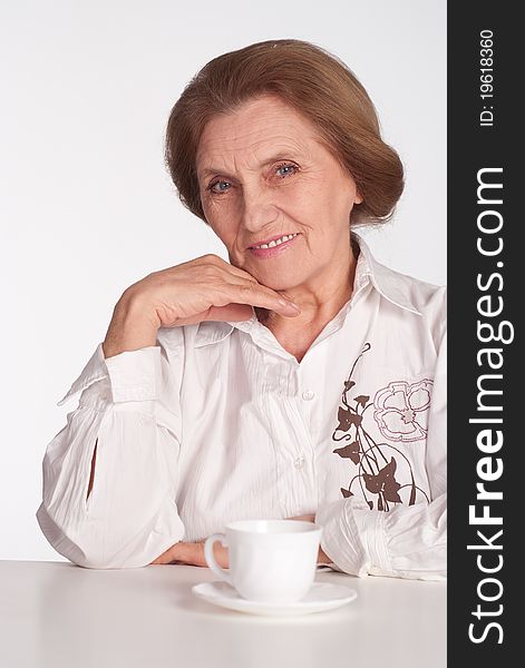 Beautiful elderly woman in a white clothes