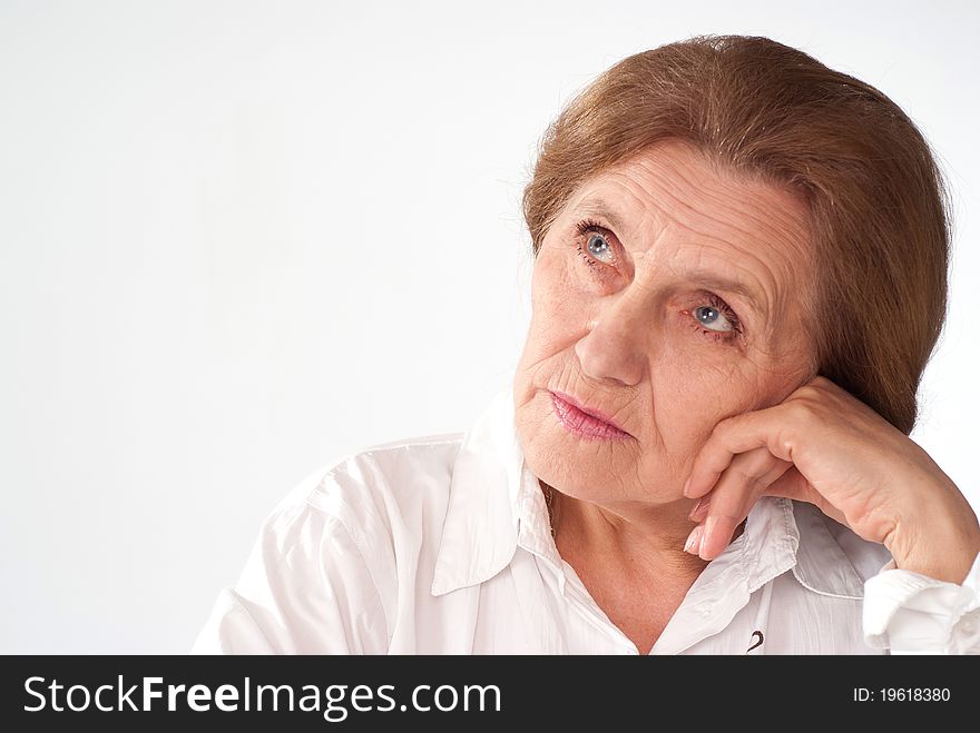 Beautiful elderly woman in a white clothes