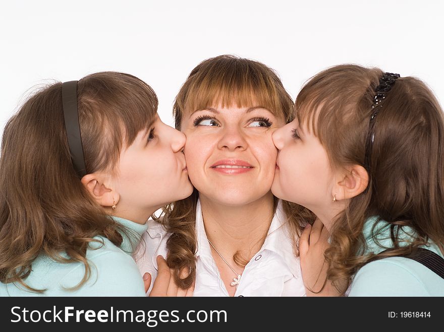 Beautiful mom and daughters on a white background. Beautiful mom and daughters on a white background