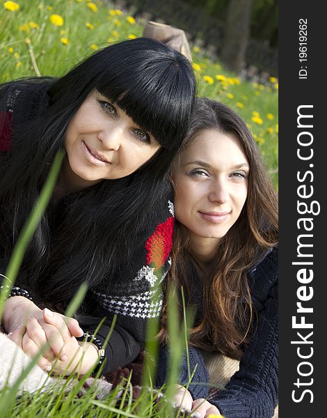 Portrait of a smiling mother and teenage daughter in park. Portrait of a smiling mother and teenage daughter in park