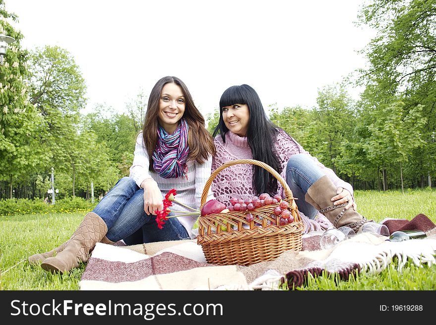 Mother And Daughter Relaxing Outdoors