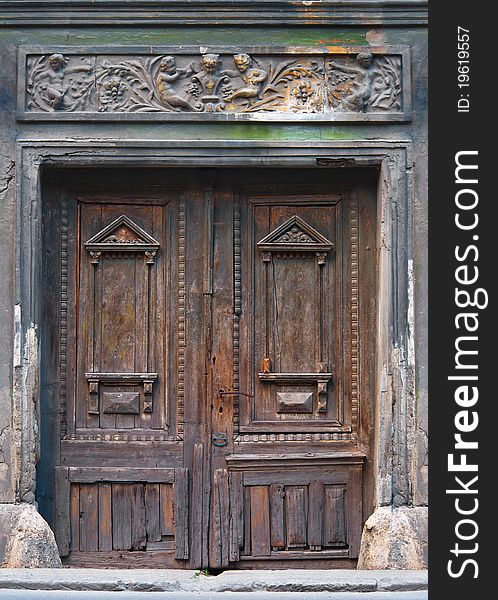 Beautiful ancient wooden door decorated with carvings and ornaments.